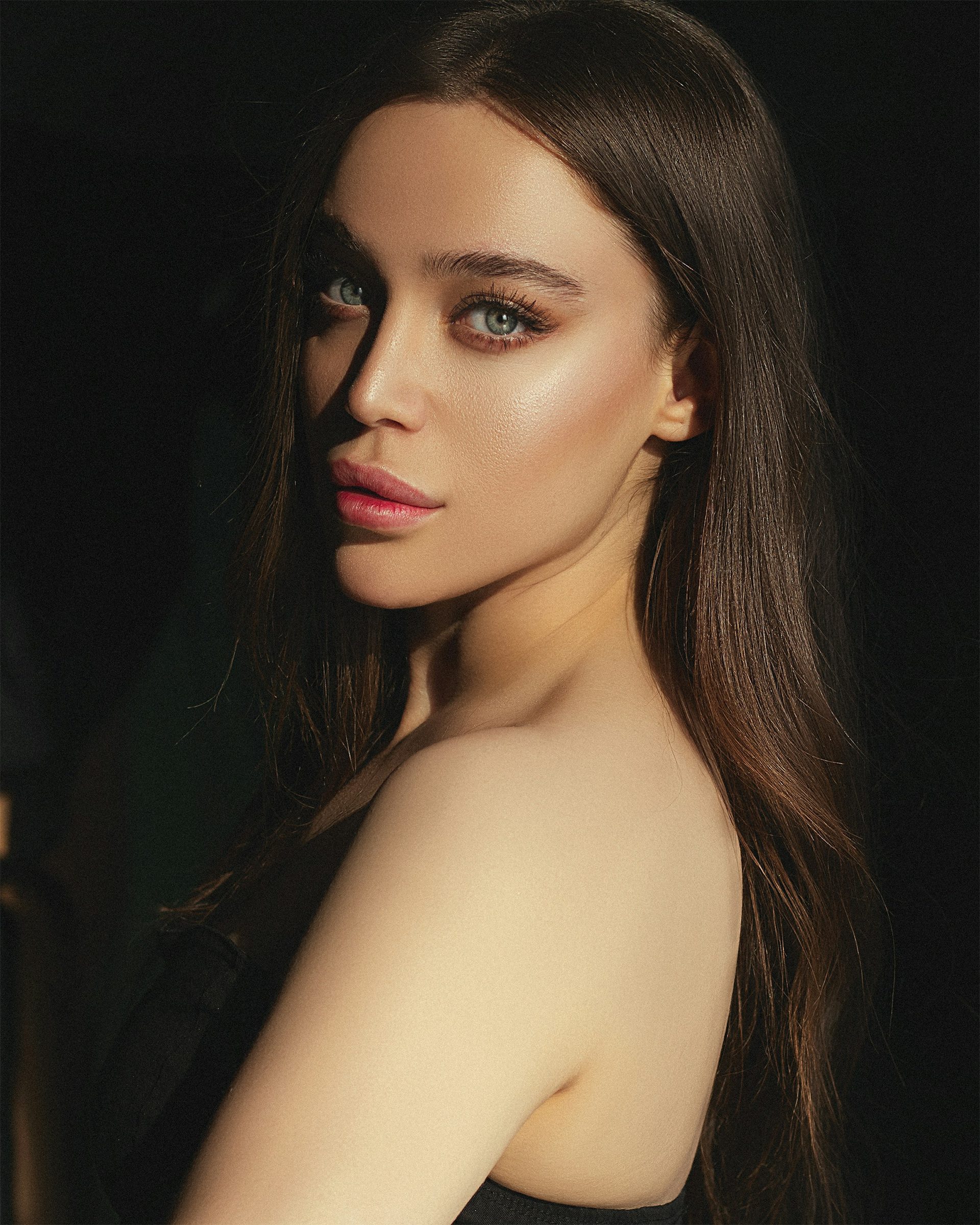 Model in soft side light, hair over one shoulder