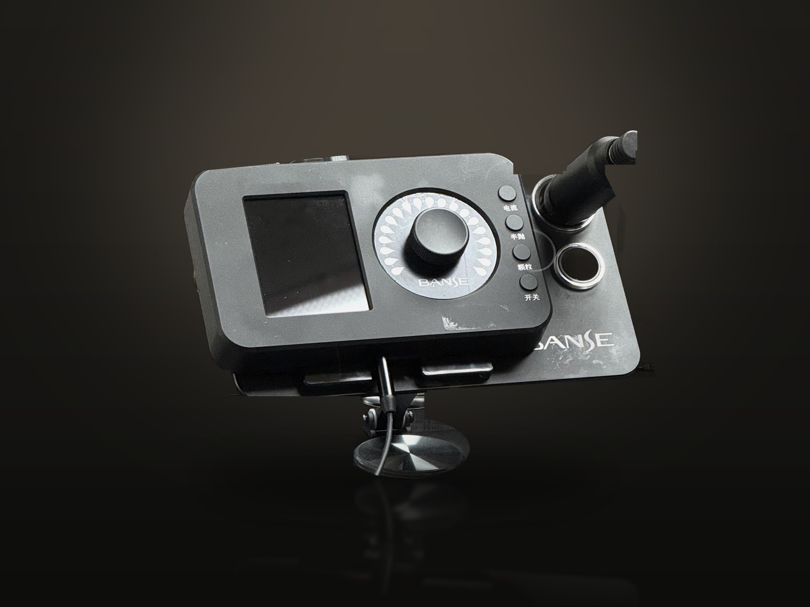 The studio's scalp micropigmentation device on a dark studio backdrop